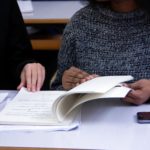 Picture of two students looking at a book.